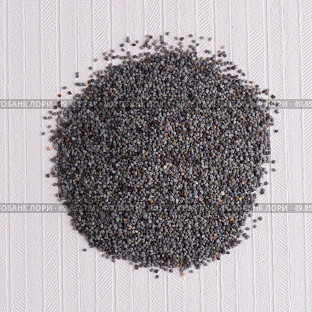 Top view of poppy seeds against white vinyl background. Стоковое фото, агентство Ingram Publishing / Фотобанк Лори