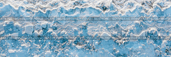 Top view of the icy shore. Winter aerial photograph of ice floes on the coast. Nature of the Extreme North. Cold frosty winter weather. Harsh arctic climate. Wide panorama. Natural background. Стоковое фото, фотограф Андрей Степанов / Фотобанк Лори