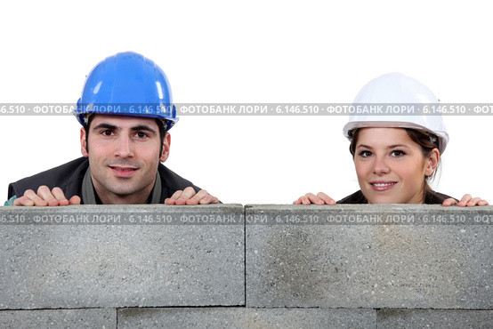Tradespeople hiding behind cinder blocks. Стоковое фото, фотограф Phovoir Images / Фотобанк Лори