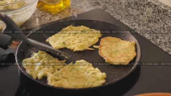 Traditional Belarusian food is fried zucchini marrow squash pancakes hot cake tortillas and garlic mayonnaise sauce. Hearty food, snack, homemade food. Vegetable pancakes decorated with parsley. Стоковое видео, видеограф Яков Филимонов / Фотобанк Лори