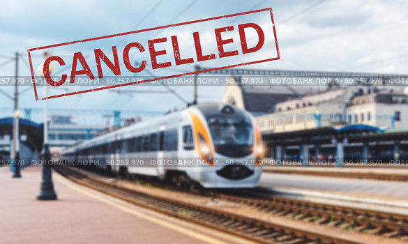 Trains cancelled due to pandemic of coronavirus. Passenger railway travel and transportation cancellation due to epidemic of Covid-19.  Background with railway station, high speed train and text . Стоковое фото, агентство Ingram Publishing / Фотобанк Лори