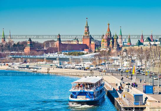 Туристический теплоход у причала. Вид на Московский Кремль. Солнечный день. Ранняя весна. Москва. Россия (2024 год). Редакционное фото, фотограф E. O. / Фотобанк Лори