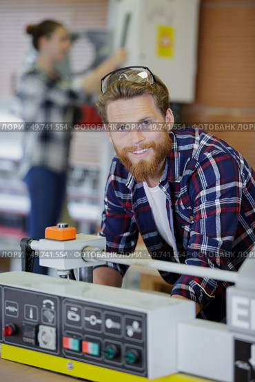 turner worker manages the metalworking process. Стоковое фото, агентство Ingram Publishing / Фотобанк Лори