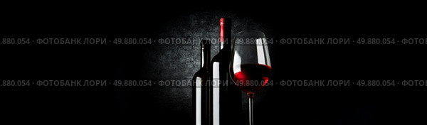 Two bottles and wineglass on a black background. Стоковое фото, агентство Ingram Publishing / Фотобанк Лори