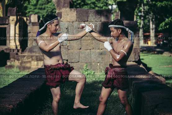 Two boxers fight with the martial arts of Muay Thai. Selective focus. Стоковое фото, агентство Ingram Publishing / Фотобанк Лори