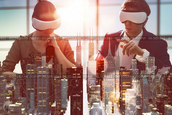 two business persons are developing a project using virtual reality goggles. the concept of technologies of the future. Стоковое фото, агентство Ingram Publishing / Фотобанк Лори
