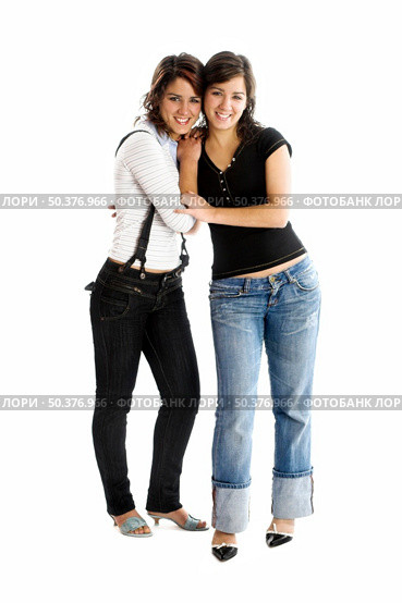Two young beautiful sisters having fun isolated on white - This models are true twins. Стоковое фото, агентство Ingram Publishing / Фотобанк Лори