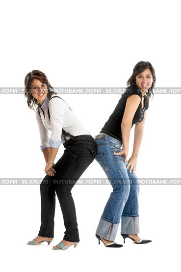 Two young beautiful sisters having fun isolated on white - This models are true twins. Стоковое фото, агентство Ingram Publishing / Фотобанк Лори