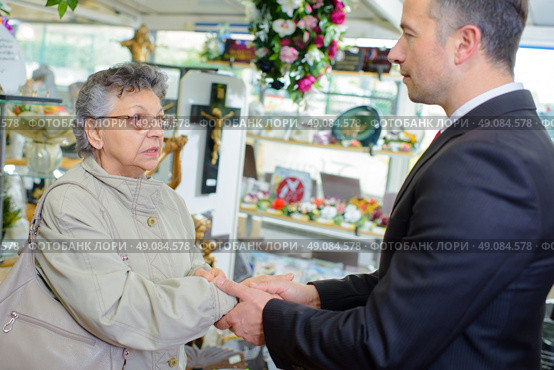 Undertaker shaking hand of elderly lady. Стоковое фото, агентство Ingram Publishing / Фотобанк Лори