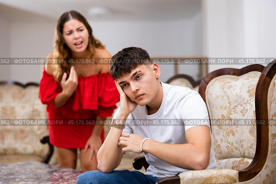 Unhappy woman quarrelling with husband at home interior. Стоковое фото, фотограф Яков Филимонов / Фотобанк Лори