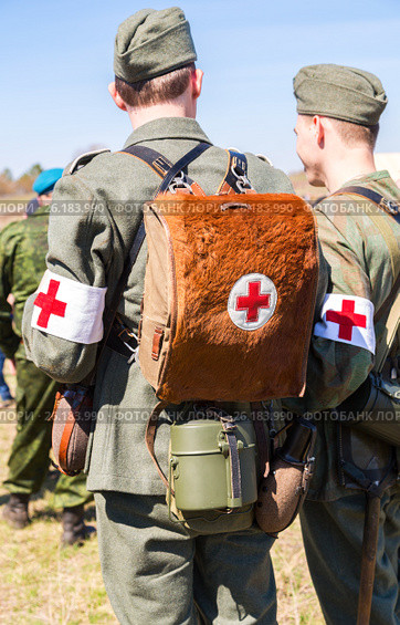 Unidentified re-enactors dressed as German military paramedic with a red cross brassard and medical bag. Стоковое фото, фотограф FotograFF / Фотобанк Лори