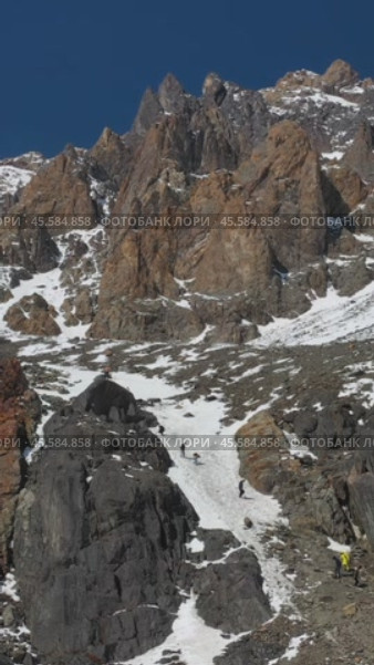 Vertical aerial video of Altai trough valley with Aktru glacier. Group of alpinists and tourists are on the slope. Стоковое видео, видеограф Сергей Пристяжнюк (Serg Zastavkin) / Фотобанк Лори