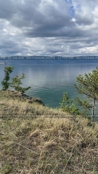 Vertical panoramic video of summer landscape of Baikal Lake on sunny day. View of Small Sea from Olkhon island coast. Natural background. Summer travels and outdoor recreation. Стоковое видео, видеограф Виктория Катьянова / Фотобанк Лори