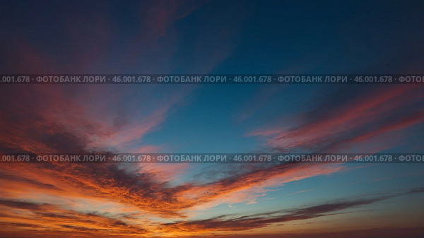 Vibrant sunset colors paint the sky above a horizon filled with tranquil clouds. Стоковое AI-изображение, AI-художник Сергей Толмачёв / Фотобанк Лори