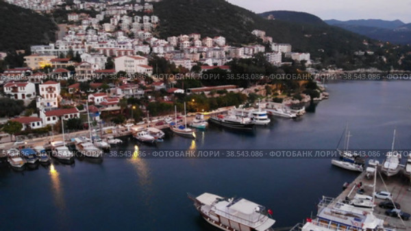 View from drone of small Turkish town of Kas on Turquoise Coast of Aegean Sea overlooking embankment and marina. Стоковое видео, видеограф Яков Филимонов / Фотобанк Лори