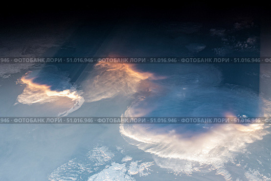 View from space of anvil cumulus clouds, crepuscular rays and Rayleigh scattering. Стоковое фото, фотограф Stocktrek Images, Inc. / ТАСС / Фотобанк Лори