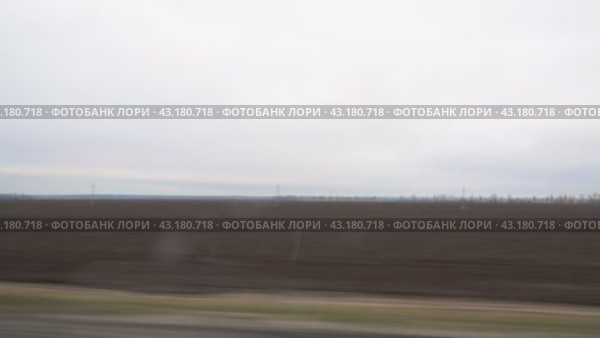 View of a plowed field from the window of a car driving on the road. Стоковое видео, видеограф Александр Прошкин / Фотобанк Лори