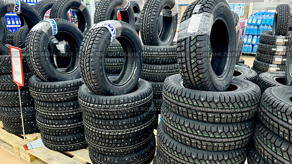 Vladimir, Russia, July 24, 2025: Winter tires at Auchan hypermarket. Редакционное фото, фотограф Igor Skripachev / Фотобанк Лори