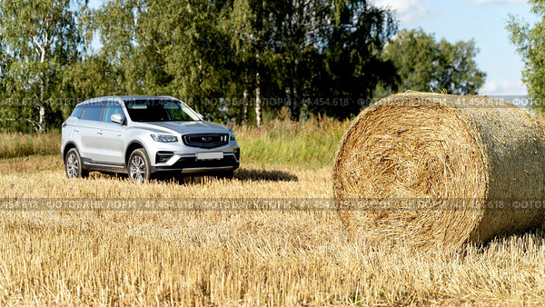 Vladimir Russia, September 04, 2021: Jili Atlas Pro car on a field with hay circles. Стоковое фото, фотограф Igor Skripachev / Фотобанк Лори
