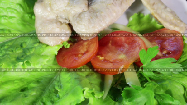 Вращающиеся куриные крылышки с помидором и листьями салата. Стоковое видео, видеограф Потийко Сергей / Фотобанк Лори