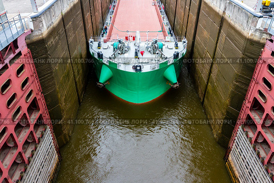 Vytegra, Russia - August 16, 2015: Cargo ship's bow entered to the White Sea-Baltic Canal Gateway. Close up image. Редакционное фото, фотограф VittoriaChe / Фотобанк Лори