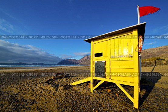 water lifeguard chair cabin red flag in spain  lanzarote  rock stone sky cloud beach  musk pond  coastline and summer . Стоковое фото, агентство Ingram Publishing / Фотобанк Лори