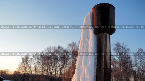 Water supply. A frozen waterfall from a water tower in a locality. Siberia. Hand held. Стоковое видео, видеограф Сергей Медведев / Фотобанк Лори