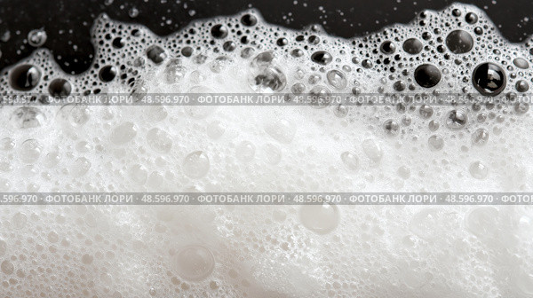 White bubbles and foam creating texture in a dark setting. Белые пузырьки и пена создают текстуру на черном фоне. Стоковое AI-изображение, AI-художник Katsiaryna Repich / Фотобанк Лори