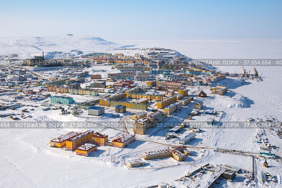 Winter landscape with the northern city of Anadyr. The administrative center of Chukotka and the most eastern city of Russia. Aerial photography of a small arctic city with colorful buildings. Snow and cold. Стоковое фото, фотограф Андрей Степанов / Фотобанк Лори