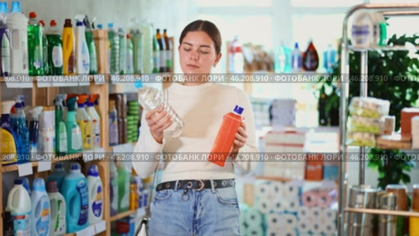 Woman chooses European means to unclog pipes at home. Buyer in search of remedies for a clog in the bathroom. Стоковое видео, видеограф Яков Филимонов / Фотобанк Лори