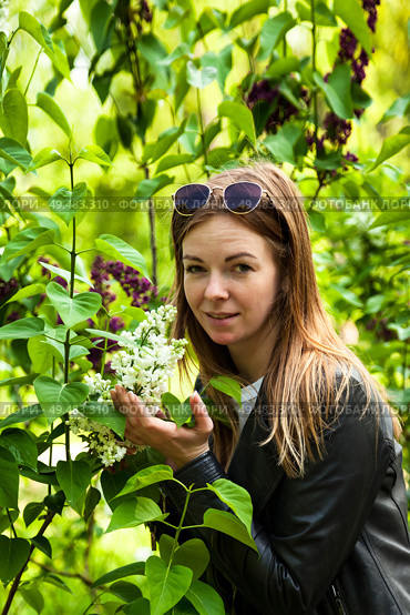 Woman Enjoying the Beauty of Spring Flowers While Exploring a Lush Outdoor Garden Setting. Стоковое фото, фотограф Aleksandr Golubev / Фотобанк Лори