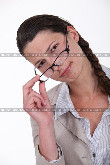 Woman peering over glasses. Стоковое фото, агентство Ingram Publishing / Фотобанк Лори