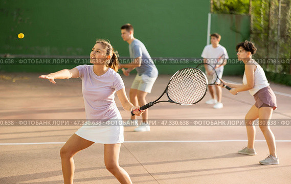 Woman playing frontenis with partners at sunny day, healthy lifestyle concept. Стоковое фото, фотограф Яков Филимонов / Фотобанк Лори