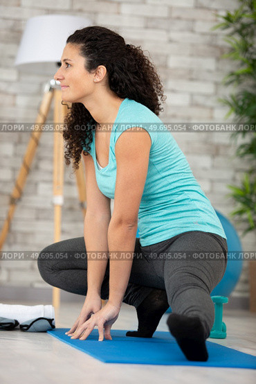 woman stretch her body at home. Стоковое фото, агентство Ingram Publishing / Фотобанк Лори