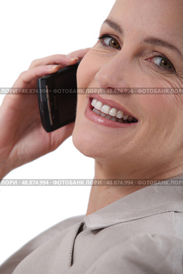 Woman stuck to the phone. Стоковое фото, агентство Ingram Publishing / Фотобанк Лори