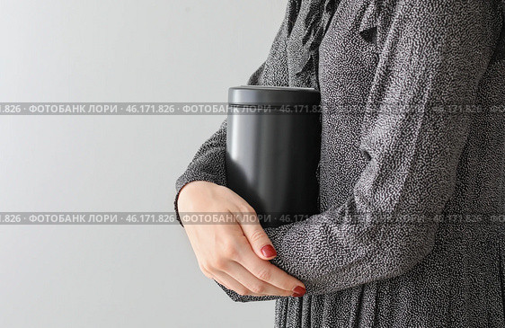 Woman with mortuary urn on light background. Стоковое фото, фотограф Pixel_shot / Фотобанк Лори