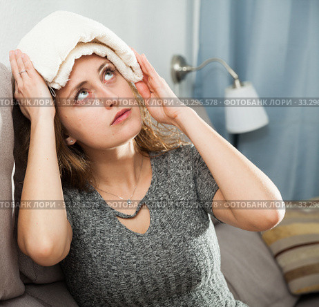 Woman with wet towel on her forehead. Стоковое фото, фотограф Яков Филимонов / Фотобанк Лори