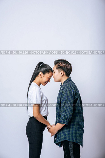 Women couples stand and fragrant cheek. Стоковое фото, агентство Ingram Publishing / Фотобанк Лори