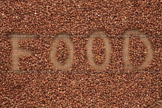 Word to  "food" write  buckwheat groats on sacking. Стоковое фото, фотограф Александр Собко / Фотобанк Лори