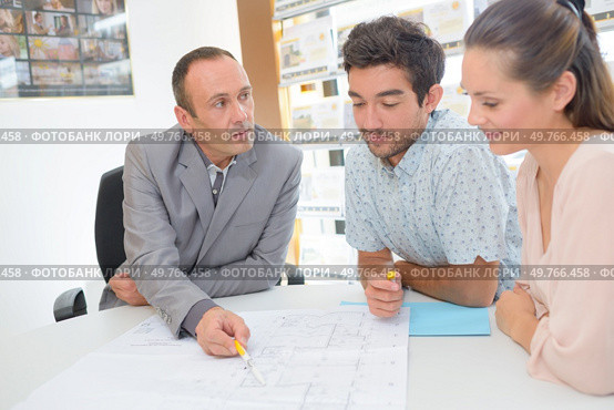 worker showing couple the floor plan. Стоковое фото, агентство Ingram Publishing / Фотобанк Лори