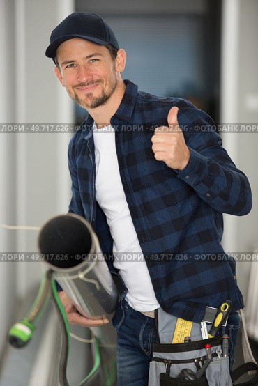 worker with gripper in hand is fixing a pipe. Стоковое фото, агентство Ingram Publishing / Фотобанк Лори