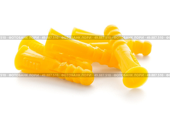 Yellow plastic dowels isolated on white background. Стоковое фото, агентство Ingram Publishing / Фотобанк Лори