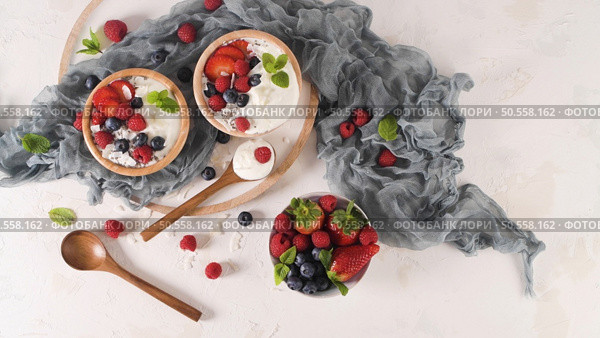 Yogurt with Chia seeds and fresh Strawberries, Raspberries, and Blueberries. Concept of Healthy Eating. Стоковое фото, агентство Ingram Publishing / Фотобанк Лори