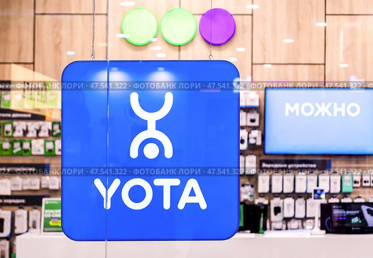 Yota/Megafon phone service in the large store. Cellular communication salon Megafon, Yota. Редакционное фото, фотограф FotograFF / Фотобанк Лори