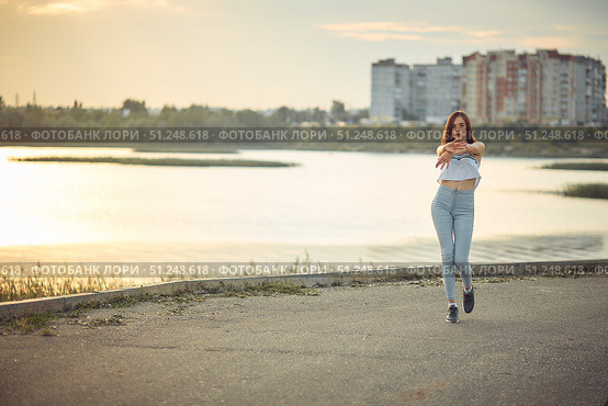 Young beautiful caucasian blonde girl listening to music with smartphone walking and dance in the city with headphones smiling - relax, youth, emancipation concept. Стоковое фото, фотограф Арзюков Вадим Николаевич / Фотобанк Лори