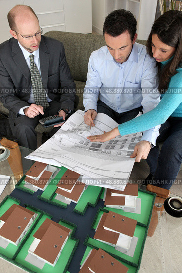 Young couple looking over new house plans. Стоковое фото, агентство Ingram Publishing / Фотобанк Лори