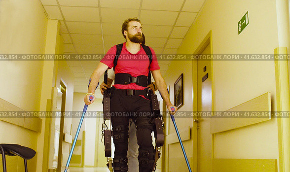 Young disable man in the robotic exoskeleton. Стоковое фото, фотограф Chudakov_Ivan / Фотобанк Лори