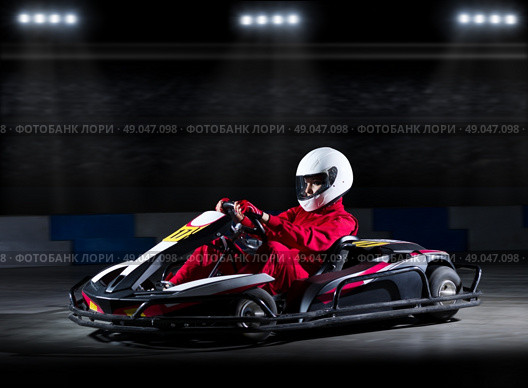 Young girl karting racer at stadium. Стоковое фото, агентство Ingram Publishing / Фотобанк Лори