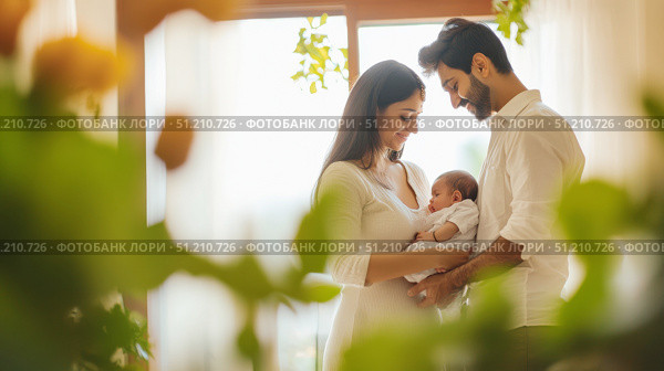 Young indian couple lovingly cares for baby in warm home setting. Стоковое AI-изображение, AI-художник Анастасия Золотницкая / Фотобанк Лори