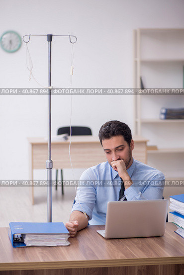 Young male employee suffering at workplace. Стоковое фото, фотограф Elnur / Фотобанк Лори